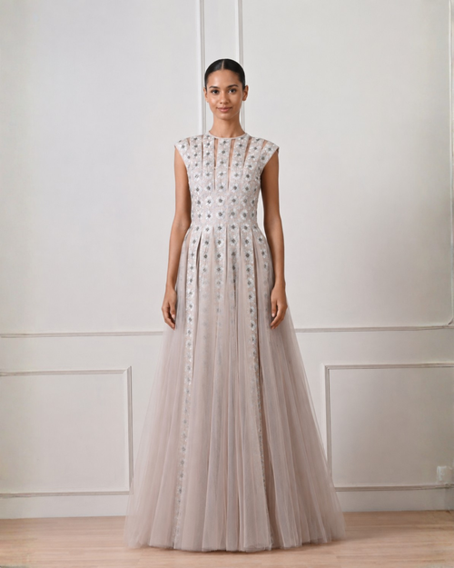 Woman wearing a long, elegant dress with a white background