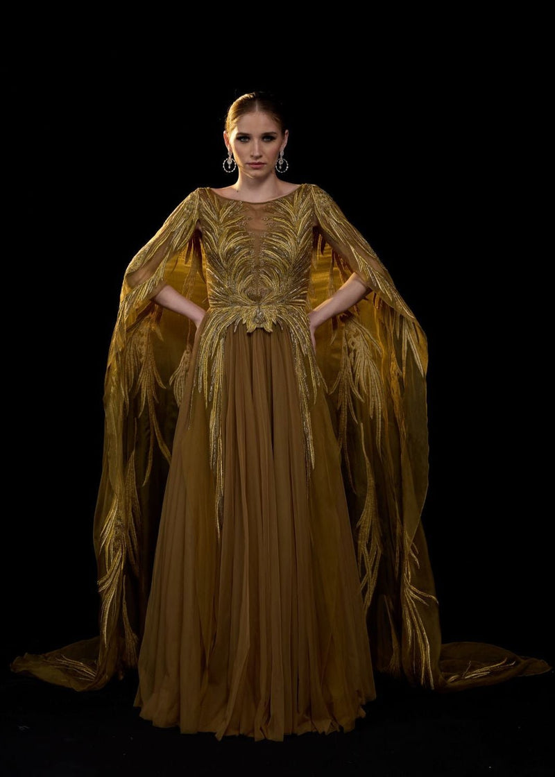 Golden-bronze embroidered gown with elegant, flowing cape sleeves