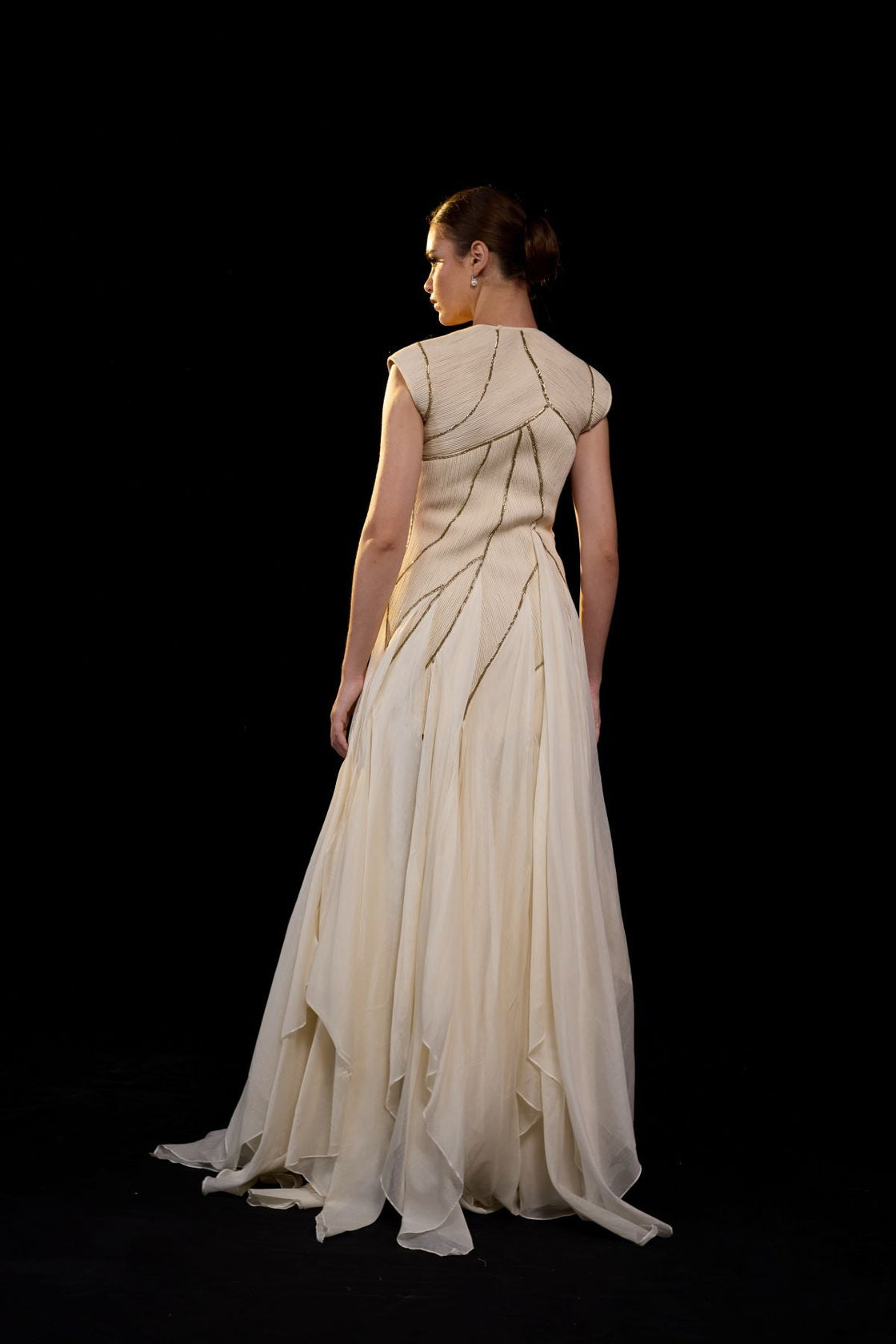 Ivory structured gown with a sculpted bodice and flowing layered panels.