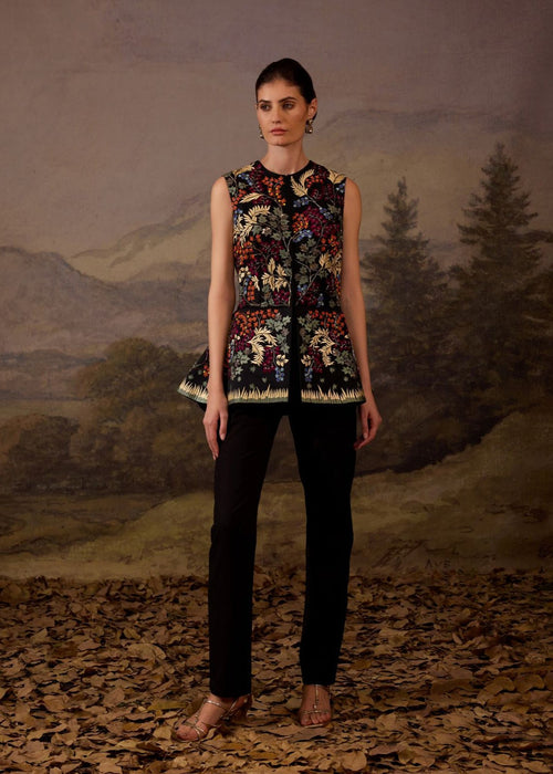 Make a statement with this exquisite black sleeveless peplum jacket.