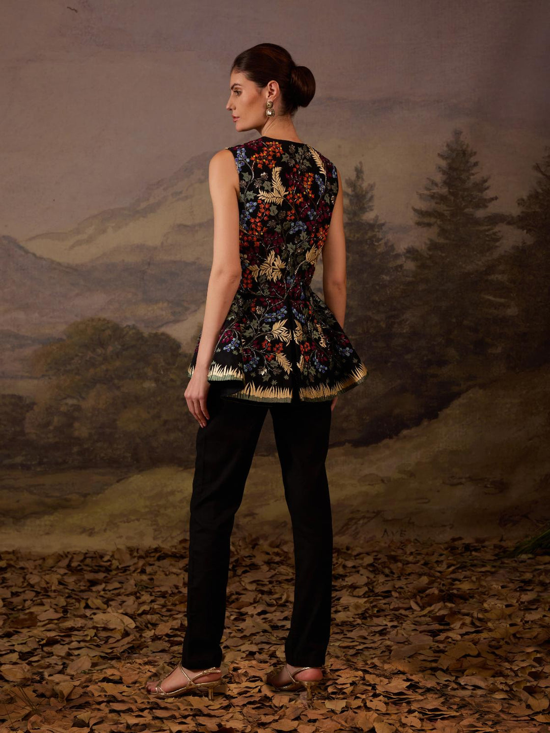 Make a statement with this exquisite black sleeveless peplum jacket.