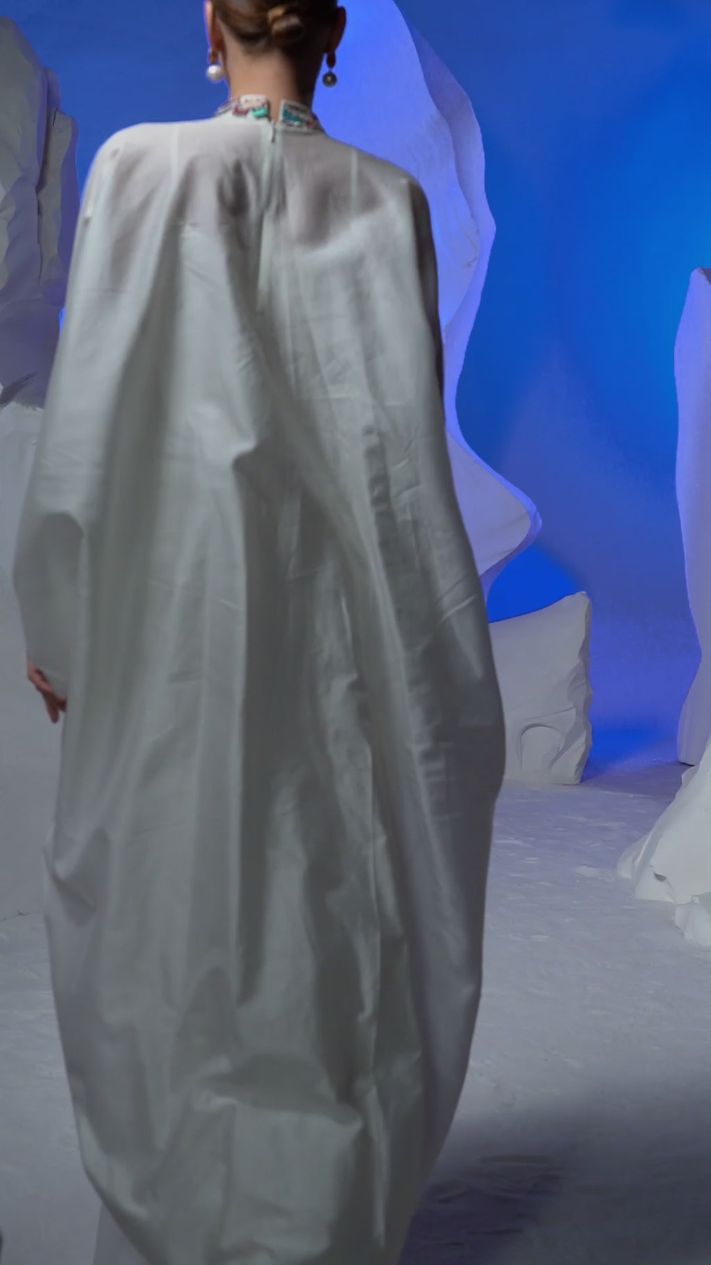 Cowl dress adorned with vibrant embroidery