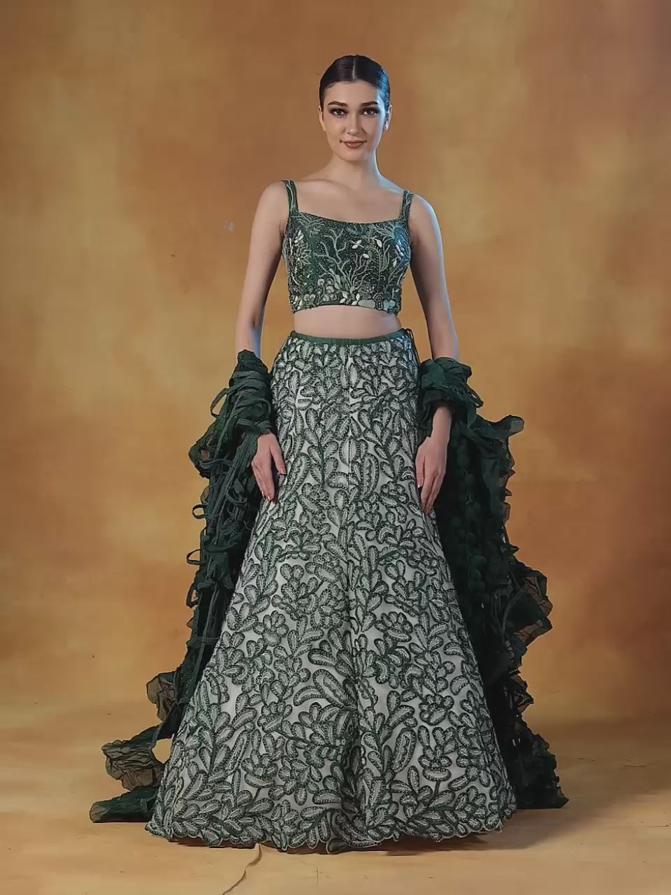 An organza silk lehenga adorned in silk appliqué work and thread embroideries.