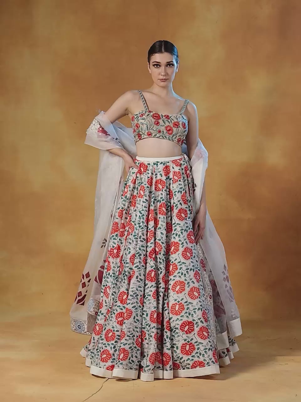 A printed lehenga set with intricately embroidered blouse and organza Dupatta