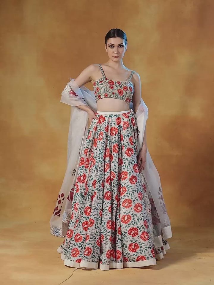 A Printed Lehenga Set With Intricately Embroidered Blouse And Organza Dupatta