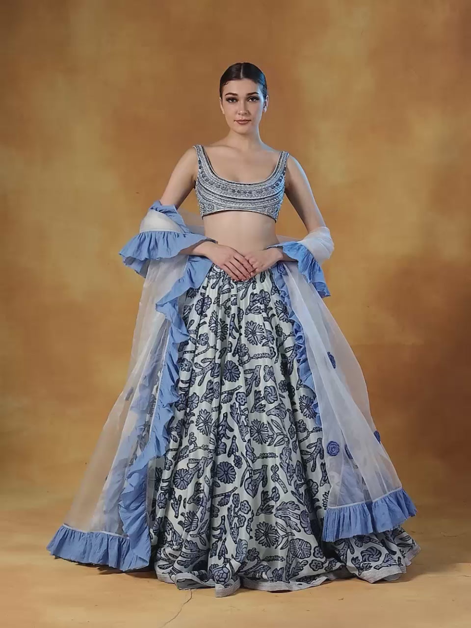 A printed lehenga set with intricately embroidered blouse and organza Dupatta with cotton frill border