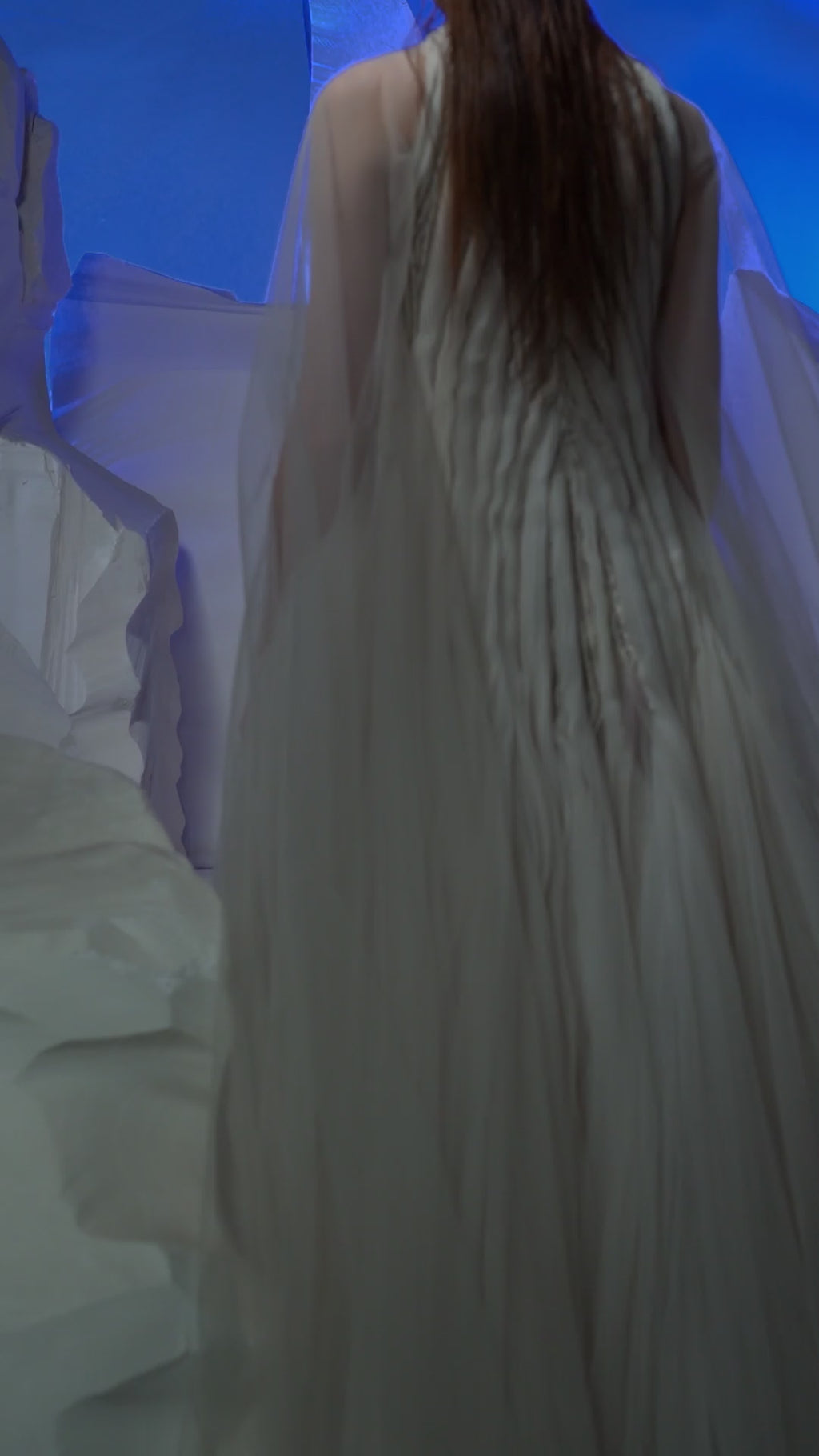 Ivory gown featuring pleating textured details.