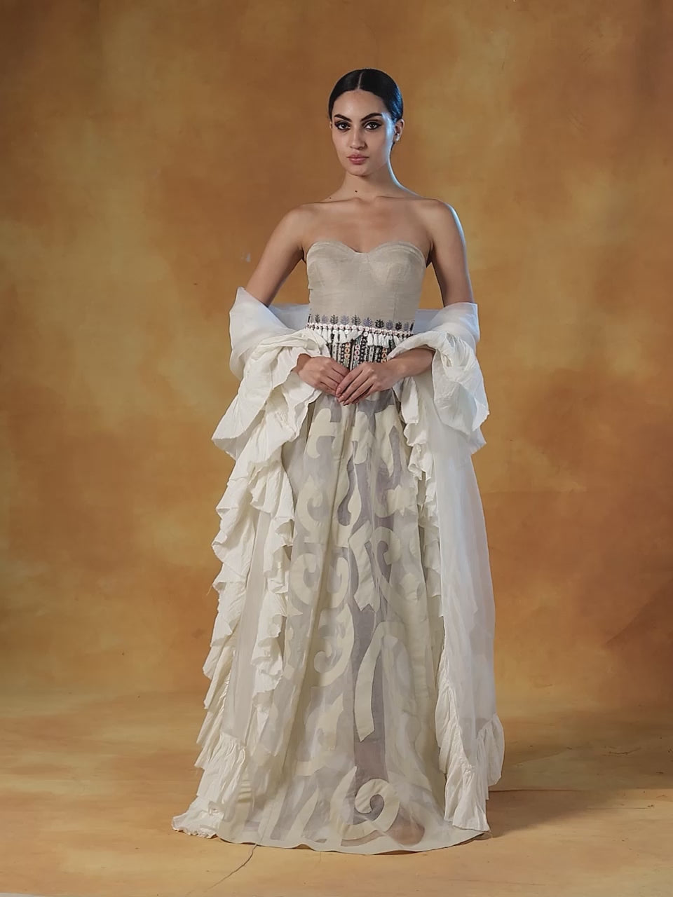 A tube corset in cotton paired with an Ivory appliqué work skirt and organza Dupatta with cotton frill.