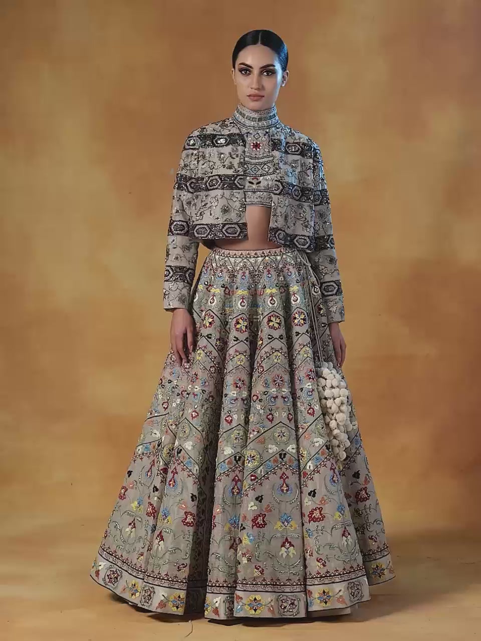 Fully embroidered lehenga set in linen silk base that is topped with a matching crop jacket.