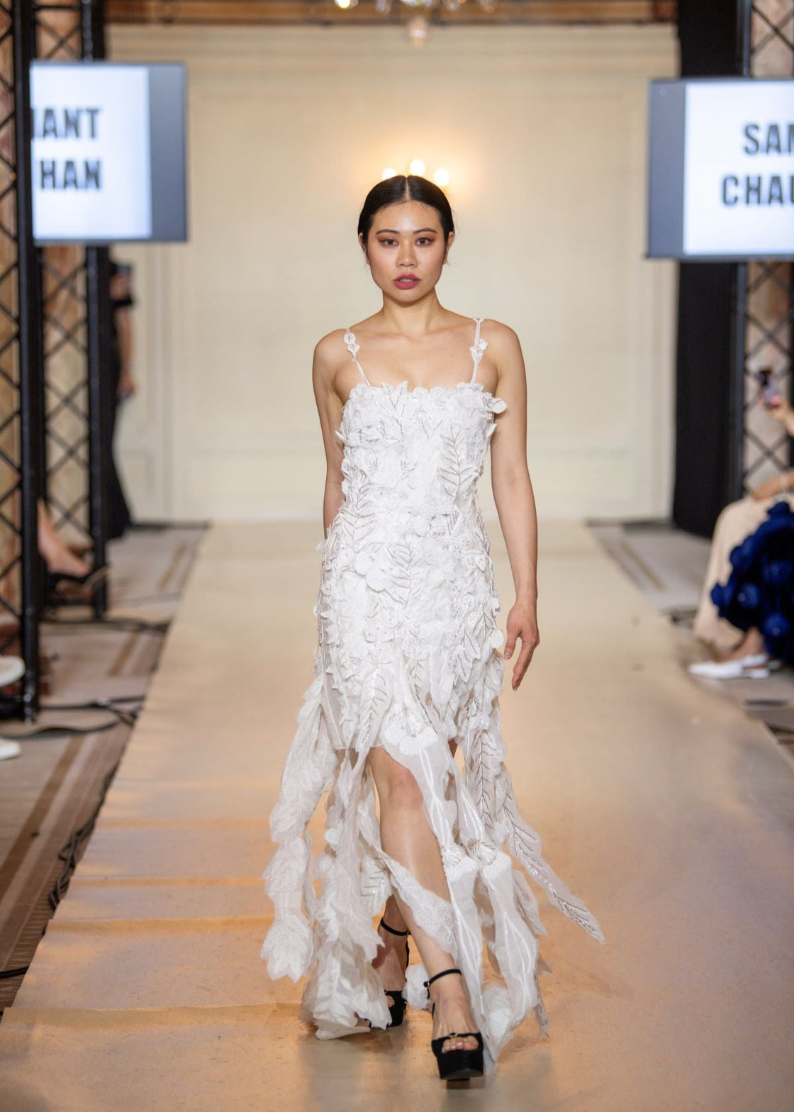Turn heads in this strappy white gown featuring delicate 3D floral appliqués