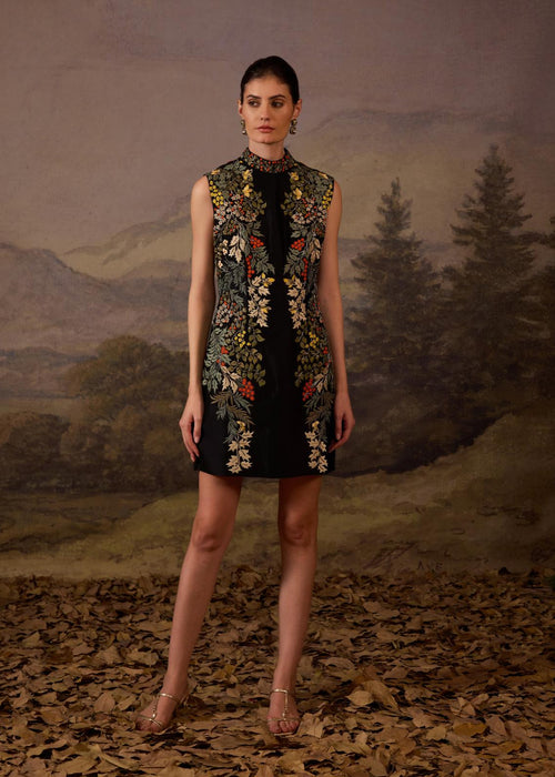 A sleeveless black mini dress features a high neckline and vibrant floral embroidery
