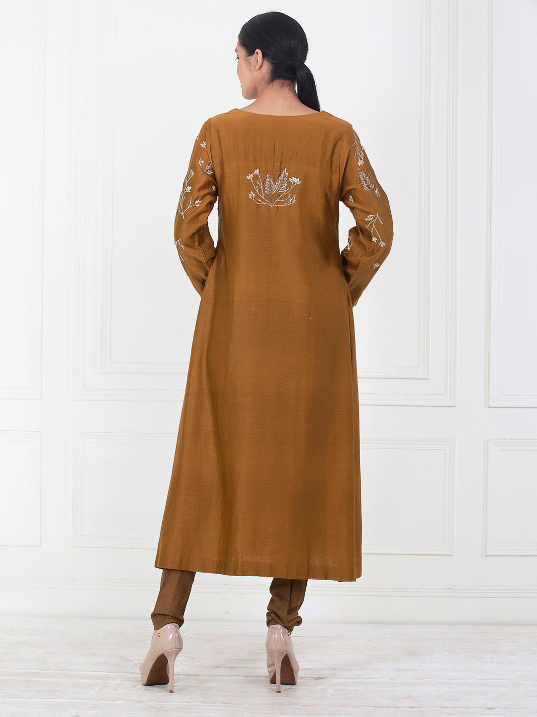 A brown cotton silk kurta that is embroidered in the front
