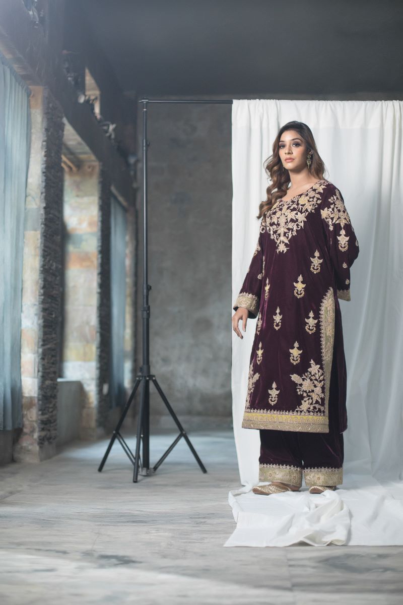 Velvet suit set adorned with zari and appliqué work and paired with organza Dupatta