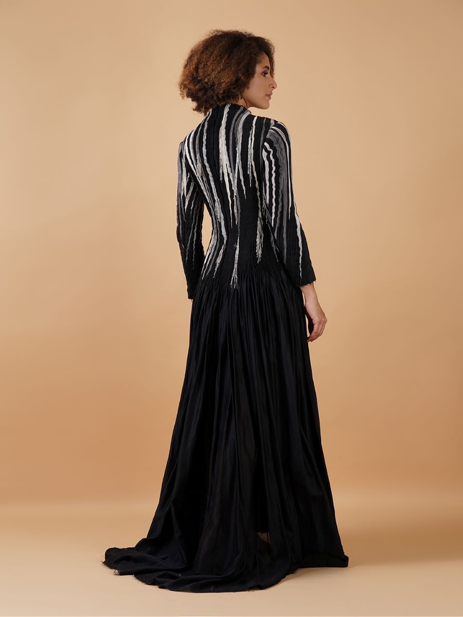 A black cotton silk, floor-length dress with high neck and full sleeves