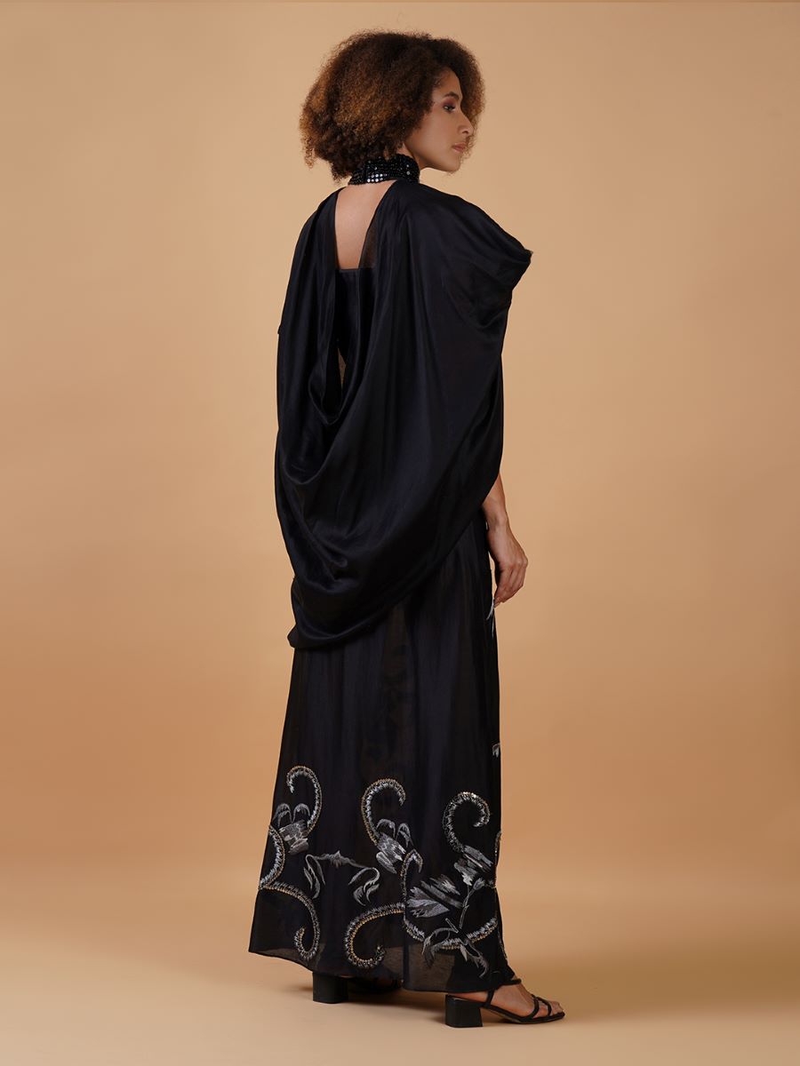 A long black cotton silk dress that has panels of silver zari embroideries
