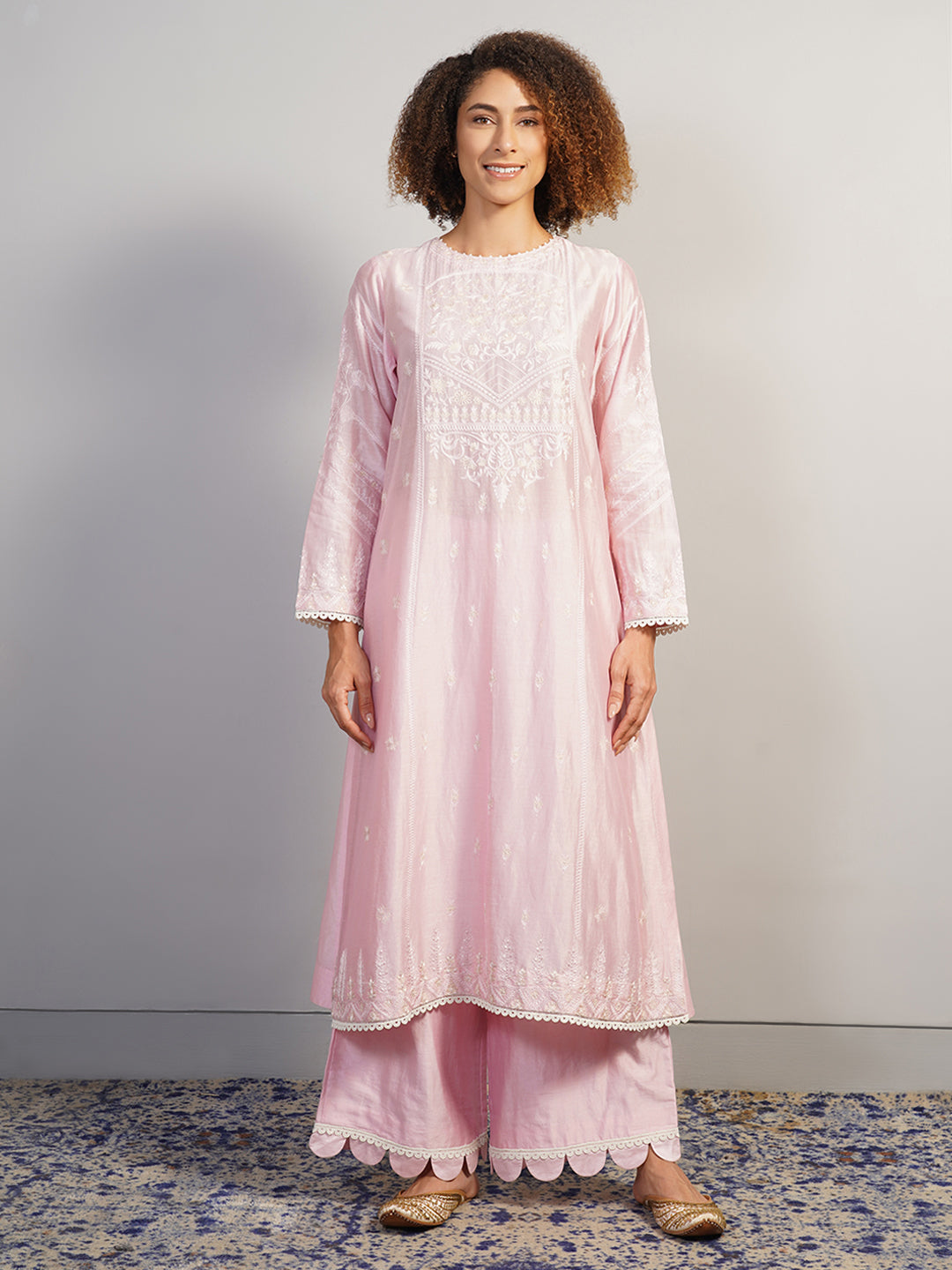 A beautiful baby pink cotton silk suit set in zero neck, adorned with intricate Aari work