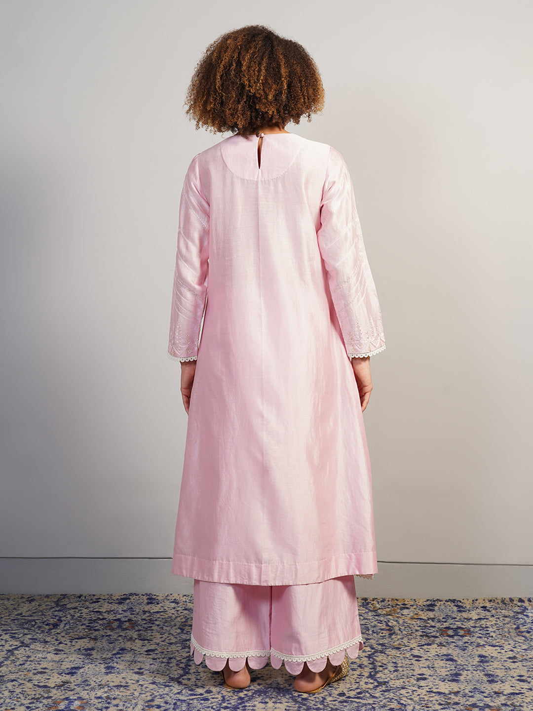 A beautiful baby pink cotton silk suit set in zero neck, adorned with intricate Aari work
