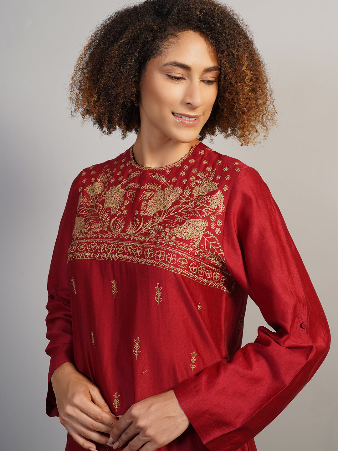 A gorgeous deep red cotton silk suit set in zero neck, showcasing rich Aari work