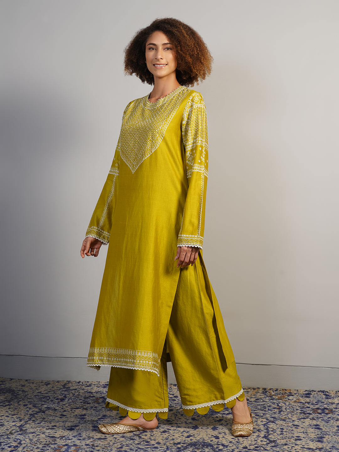 A lovely warm olive cotton silk suit set that is intricately embroidered in Aari work