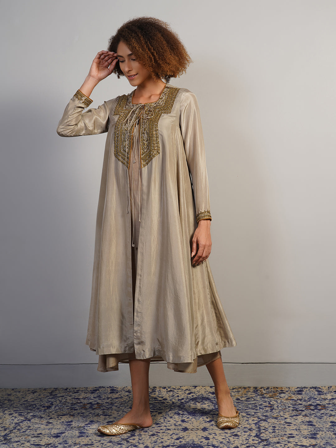 A warm grey silk suit set that is open in the front and secured with a knot at the squared neckline