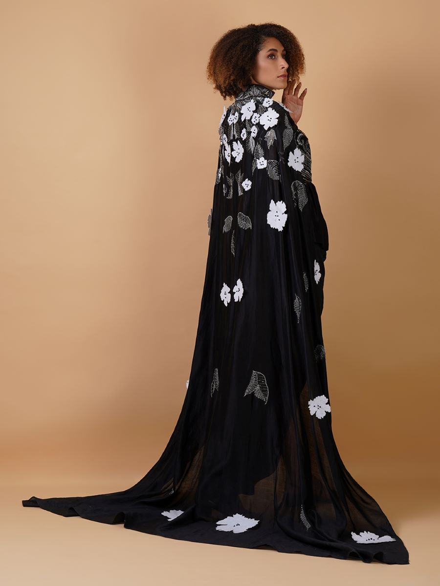 A black cotton silk dress that gives the illusion of a dhoti from front with cowls falling