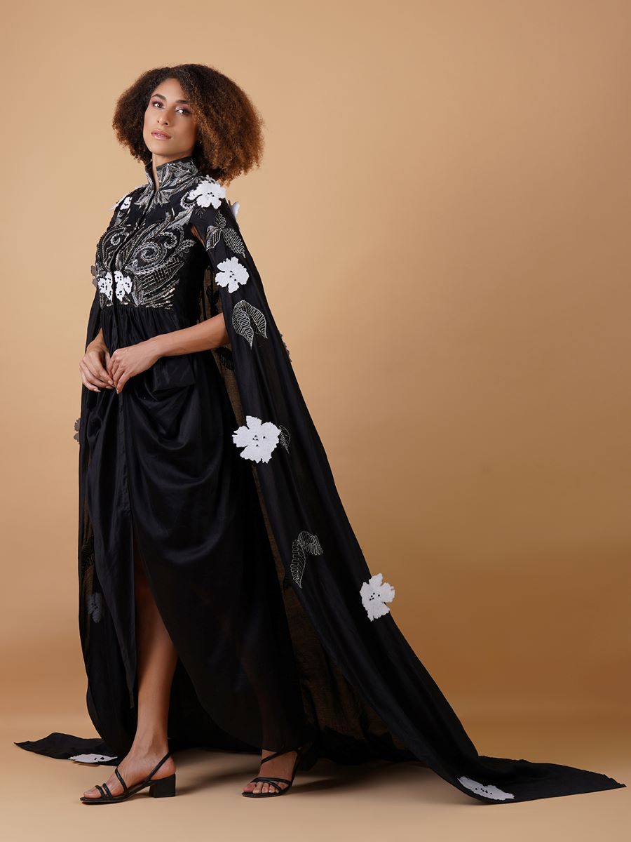A black cotton silk dress that gives the illusion of a dhoti from front with cowls falling