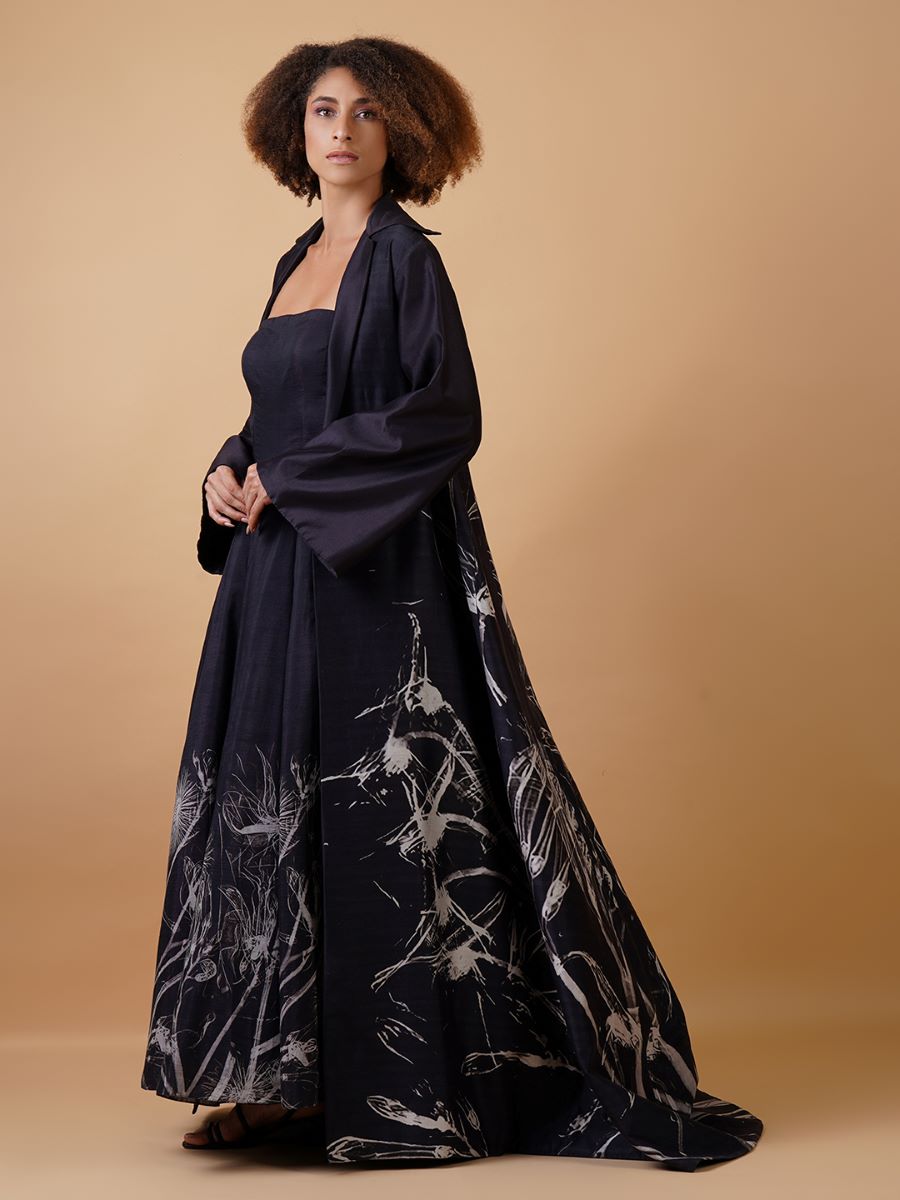 A black cotton silk tube dress paired with a jacket in the same fabric