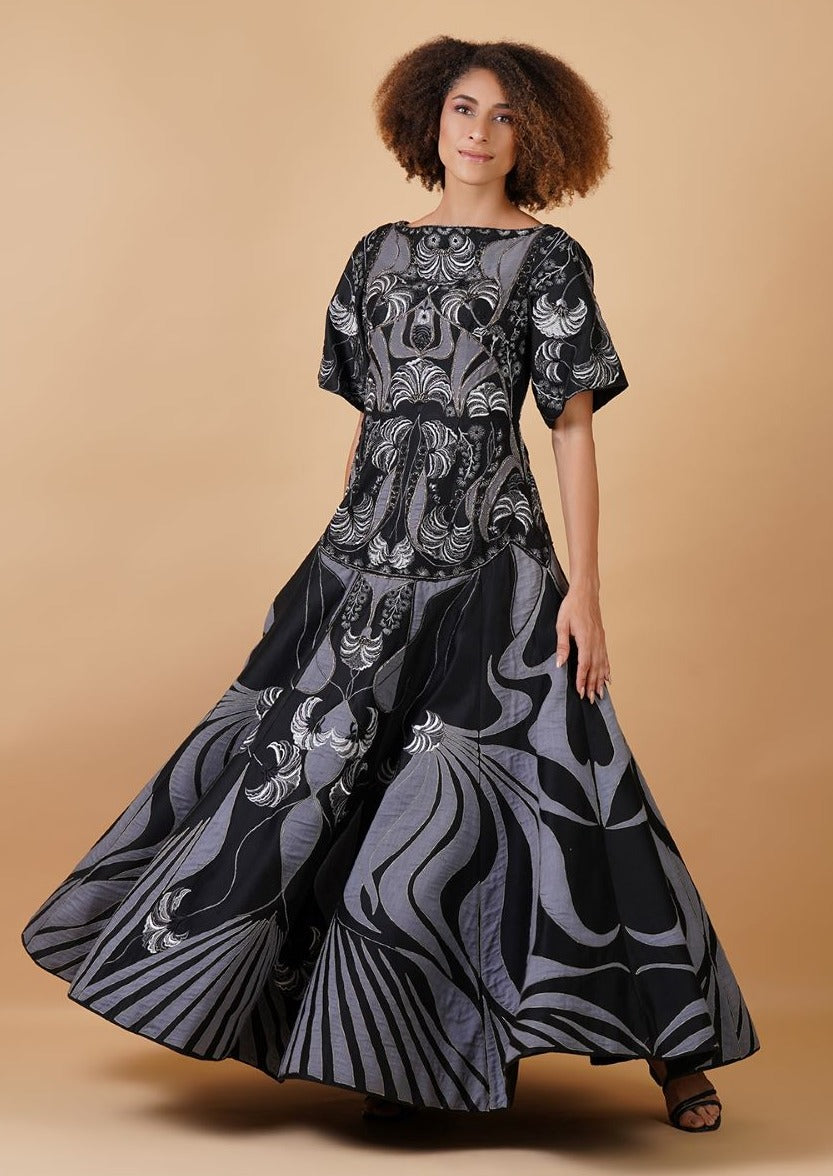 A long cotton silk dress that is adorned with appliqué work
